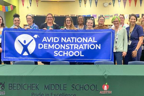 Teachers holding a banner that reads "AVID National Demonstration School"